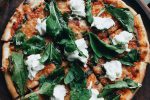 pizza with green leaves on top