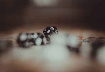white and black dice on brown wooden table
