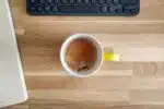 yellow ceramic mug on brown wooden table