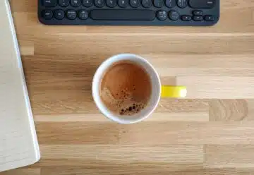 yellow ceramic mug on brown wooden table