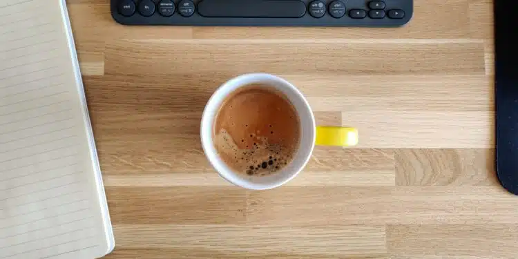 yellow ceramic mug on brown wooden table